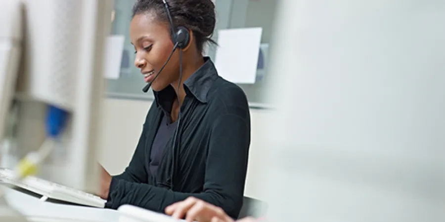 graphicstock-female-african-american-customer-service-representative-talking-on-the-phone-and-typing-on-pc-horizontal-shape-side-view-copy-space_r2vyWO9DZ (1).jpg